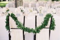22 ivory fabric and a lush foliage garland to make the sweetheart chairs stand out and look inspiring