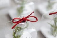 23 wedding favors with red suede and rosemary and faux snow inside is a cute idea