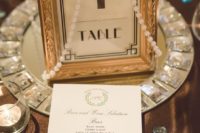 24 a glam table number with strands of perlas on a silver tray is a perfect fit for an Old Hollywood wedding