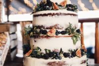 24 a semi naked wedding cake with blueberries, figs, blackberries and thistles and foliage