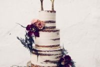 25 a semi naked wedding cake with gilded antler toppers, burgundy blooms and greenery