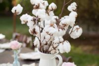 25 cotton branches in a jug, pink roses and vintage books for decorating the wedding tablescape