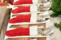 25 knit red and white stockings as utensil covers for a Christmas wedding