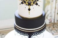 26 a black and white wedding cake with edible yellow and black beads and rhinestones looks wow