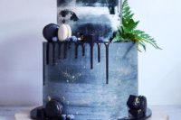 26 a watercolor blue wedding cake looks dramatic and moody with navy drip, fern and macarons in navy and white