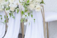 26 pure white chair covers with lush white flowers and foliage for a lush spring or summer wedding