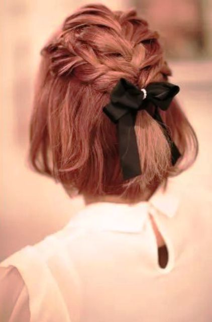 red short hair with braids on top and a black bow with rhinestones for an elegant modern bride