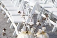 27 glittered pumpkins with cotton branches are ideal for decorating a rustic fall aisle