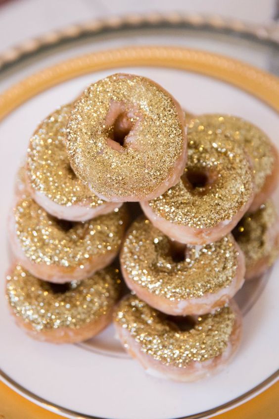 donuts covered with gold glitter are a cool and bold idea for any dessert table