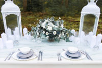 29 grey chargers, an ice blue table runner and a pale green and white floral centerpiece are a great choice