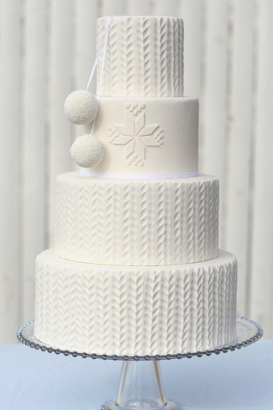 a gorgeous knit cake with edible pompoms and traditional knit patterns