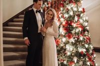 a beautiful Christmas tree with red ornaments, poinsettia blooms, lights is a gorgeous idea for a Christmas wedding ceremony