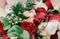 a bold and chic wedding bouquet with white, blush and burgundy blooms, greenery and berries for a winter wedding