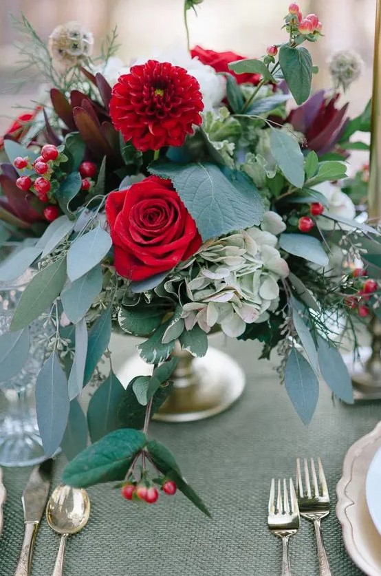 a chic floral wedding centerpiece with red roses, hydrangeas, dahlias and lots of lush greenery