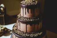 a fab chocolate wedding cake with chocolate drip, nuts on each tier and on the top is a timeless and cool idea for any type of wedding