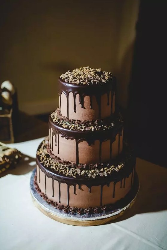 a fab chocolate wedding cake with chocolate drip, nuts on each tier and on the top is a timeless and cool idea for any type of wedding