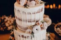 a naked wedding cake with creamy drip, with wildflowers, thistles and glazed donuts for a winter rustic wedding