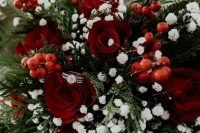 a timeless winter wedding bouquet of ferns, baby’s breath, red roses and berries is a very bold idea
