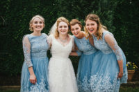 02 The bride was wearing a lace applique wedding dress with a V neckline and half sleeves, and the bridesmaids were wearing blue gowns with illusion sleeves
