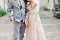 02 a blush wedding dress with a plunging neckline, long lace sleeves and an embellished sash
