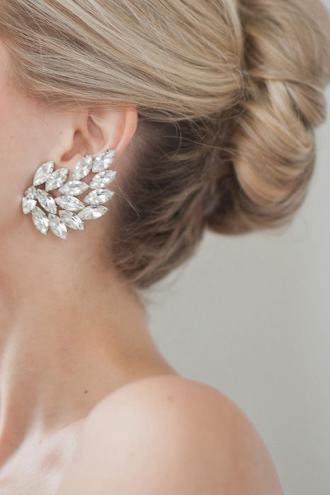 a bold statement earring with large rhinestones shaped as a leaf