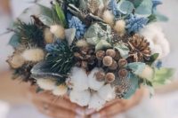 02 a gorgeous winter bouquet with evergreens, cottons, pinecones and feathers