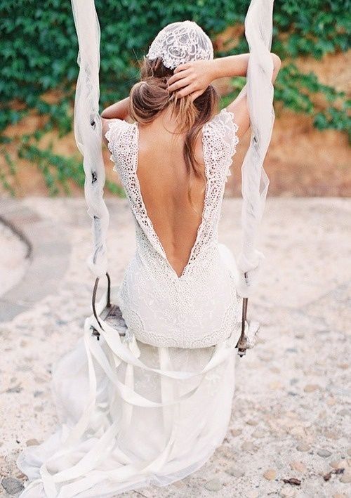 a boho lace wedding dress with a low cutout back, no sleeves and a cap veil for a cool matching look