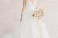 04 The first bridal look was done with a strapless sweetheart neckline wedding dress with a ruffled skirt