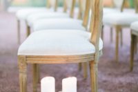 04 line up your wedding aisle with pillar candles, foliage and citrus to make it look chic