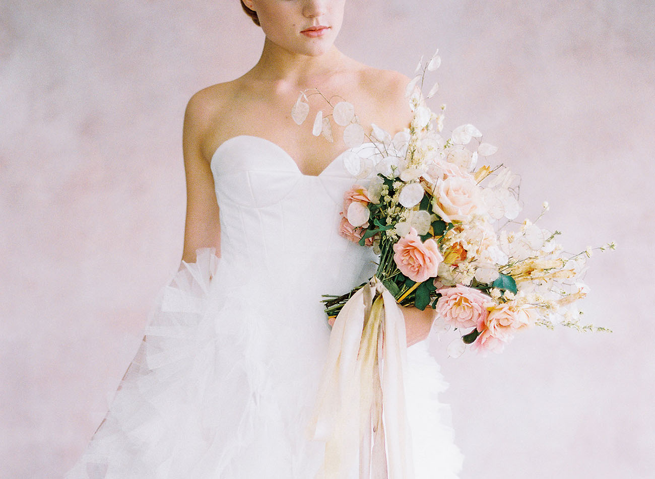 The ethereal bridal bouquet was done with blush roses and some airy touches