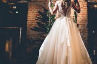 05 a gorgeous wedding dress with a lace bodice, a V cut on the back and a layered skirt with a train