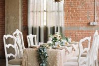 06 a blush sequined tablecloth, a greenery table runner will be a nice idea for a winter bridal shower