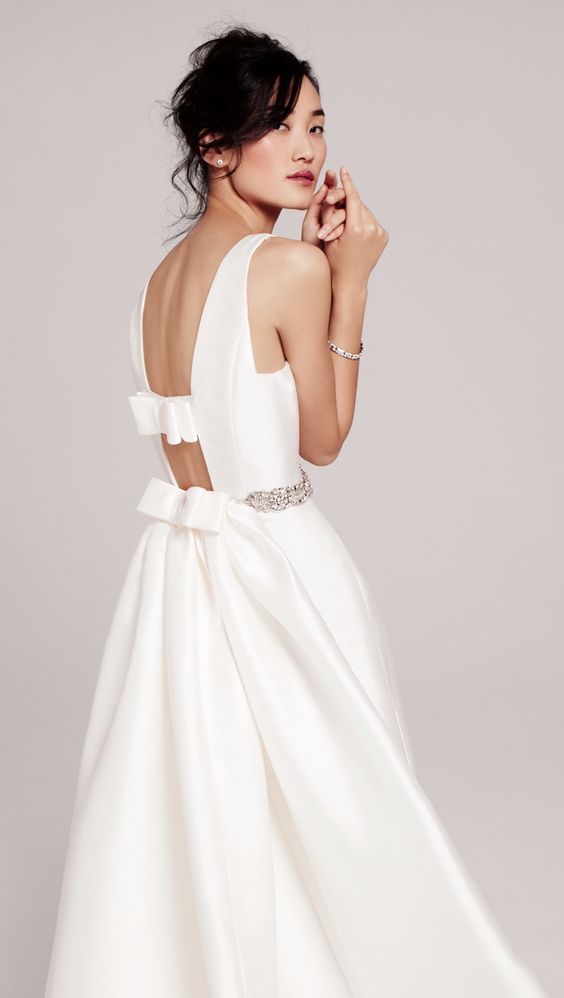 a cutout back with bow detailing makes this dress special and adds a playful touch