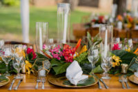 08 The tables were decorated with runners of tropical leaves and colorful flowers, geometric candle holders