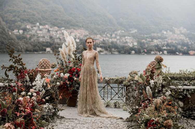 What a gorgeous wedding dress and a lush floral setting
