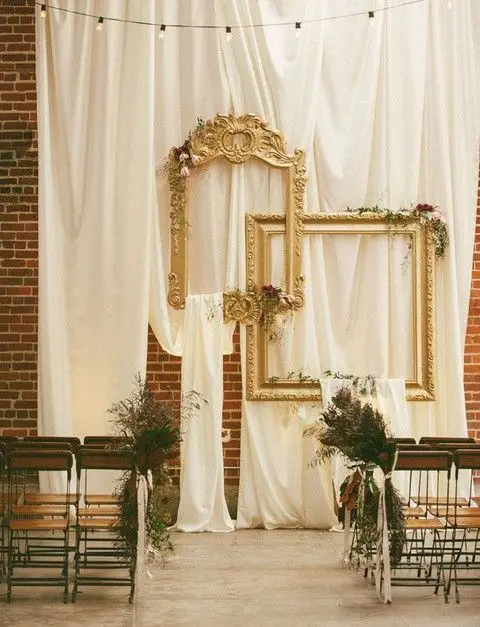 draped fabric and vintage refined picture frames for a vintage-inspired wedding