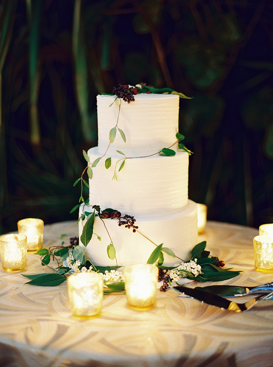 The wedding cake was a textural white one, with fresh greenery and berries and candles around