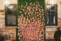 09 a living wall with real orange and pink blooms and a couple of glam chandeliers completely changes the venue