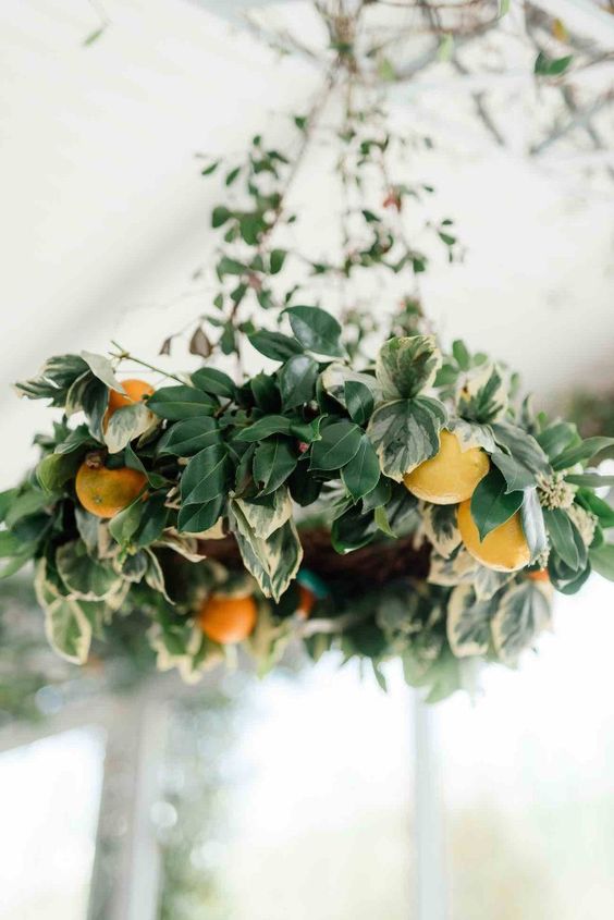 a lush foliage and orange chandelier will make your venue more eye catching and gorgeous