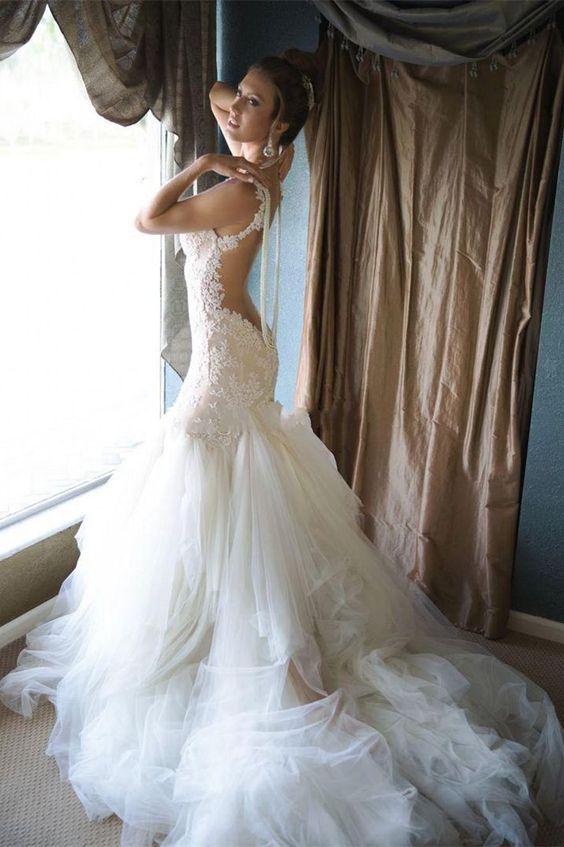 mermaid wedding dress without sleeves, with an open back and a layered skirt with a long train