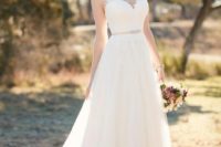 11 chic A-line sleeveless wedding dress with an illusion neckline, an embellished belt and a plain skirt