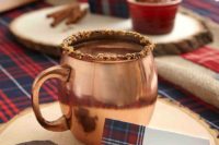 11 rock copper mugs and wood slice coaters for your hot cocoa station to give it a cute rustic look