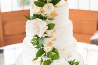 12 The wedding cake was a white one with gold leaf and white and blush blooms and greenery