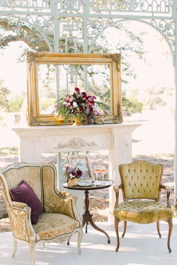 an exquisite outdoor lounge with refined chairs, a faux fireplace and a vintage frame