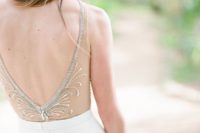 12 an open back with a sheer detail, embroidered and beaded to make it more exquisite