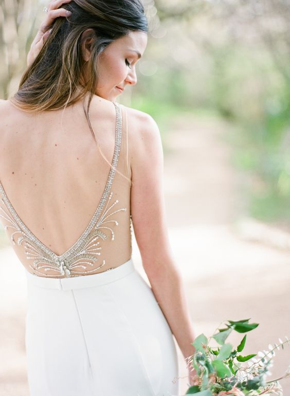 an open back with a sheer detail, embroidered and beaded to make it more exquisite