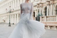 13 a dove grey wedding dress with a lace bodice and long sleeves and a layered skirt