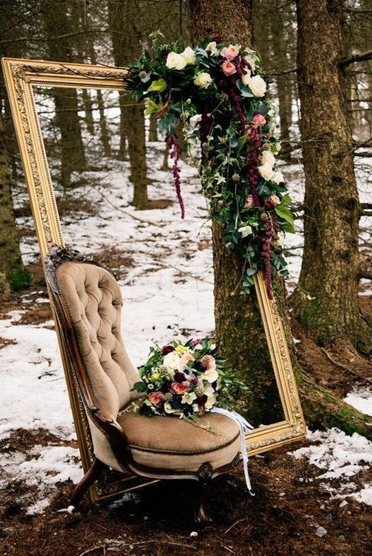 a unique outdoor photo space with a refined vintage frame and chair and lush moody florals