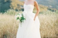 14 a modern wedding gown with an illusion sweetheart neckline, no sleeves and a layered skirt