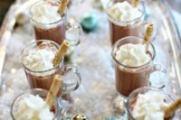 14 serve hot chocolate on a tray with faux snow and ornaments to make the drinks look cooler